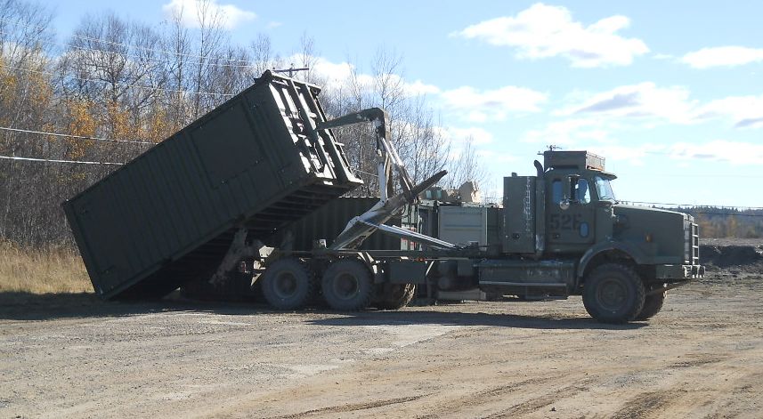 20-FT Shipping container being moved by a purpose built military truck