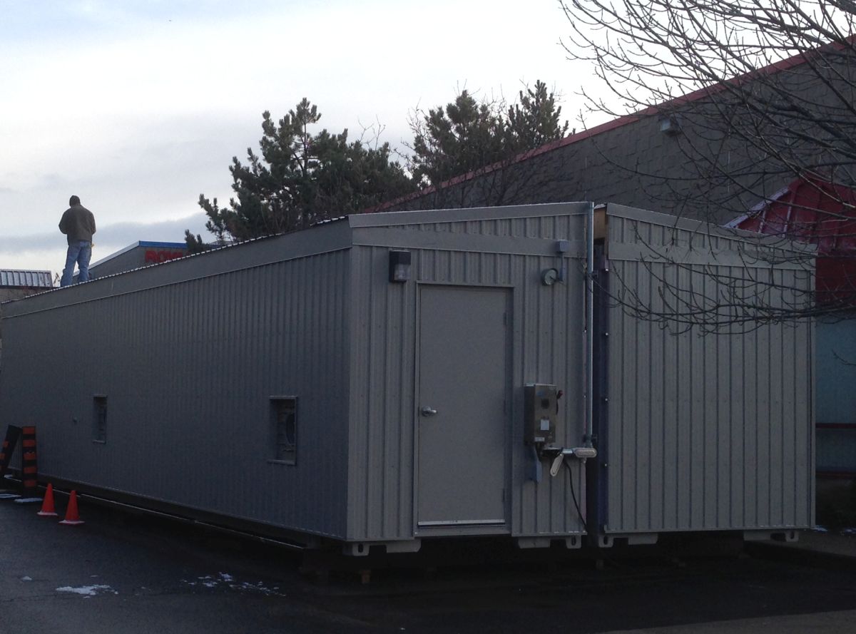 40 Foot shipping containers getting checked to make sure they can be joined together in the field