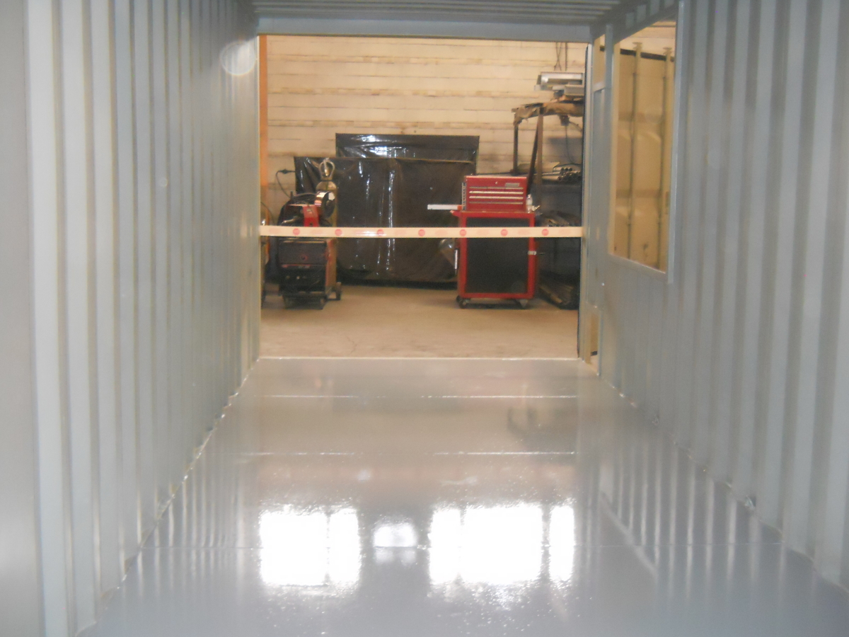20 FT Shipping container in the process of have openings cut for access doors and and piping