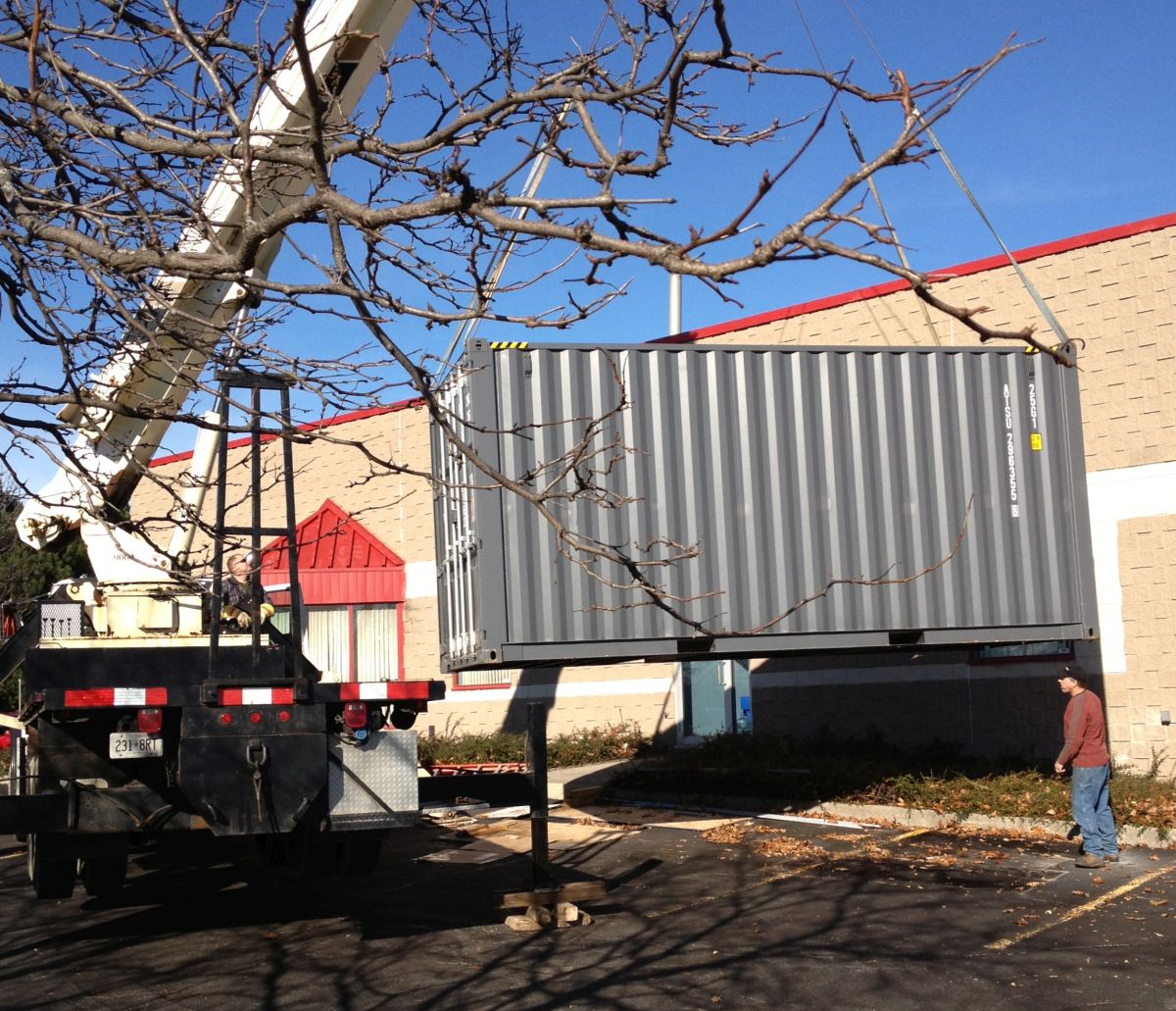 20 FT Shipping container being lifted onto a temporary base for modifications 20 FT Shipping container being lifted onto a temporary base for modifications
